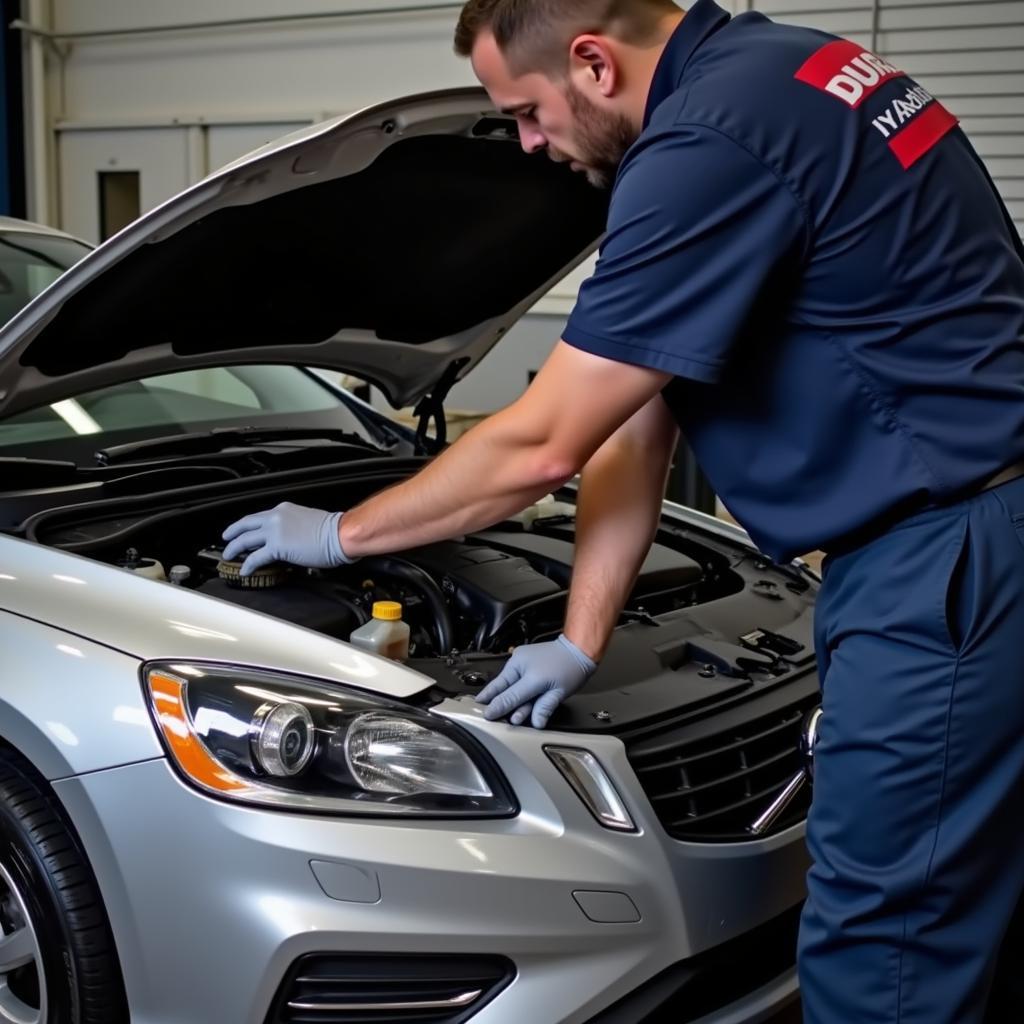 Mechanic checking the brake fluid level in a Volvo S60