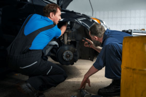 Close-up of a car bumper being repaired, showcasing dent removal and smoothing techniques