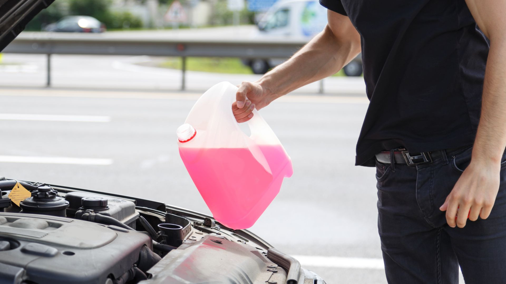 A person adding antifreeze to a car radiator, demonstrating a simple maintenance task to ensure proper engine cooling and heating.