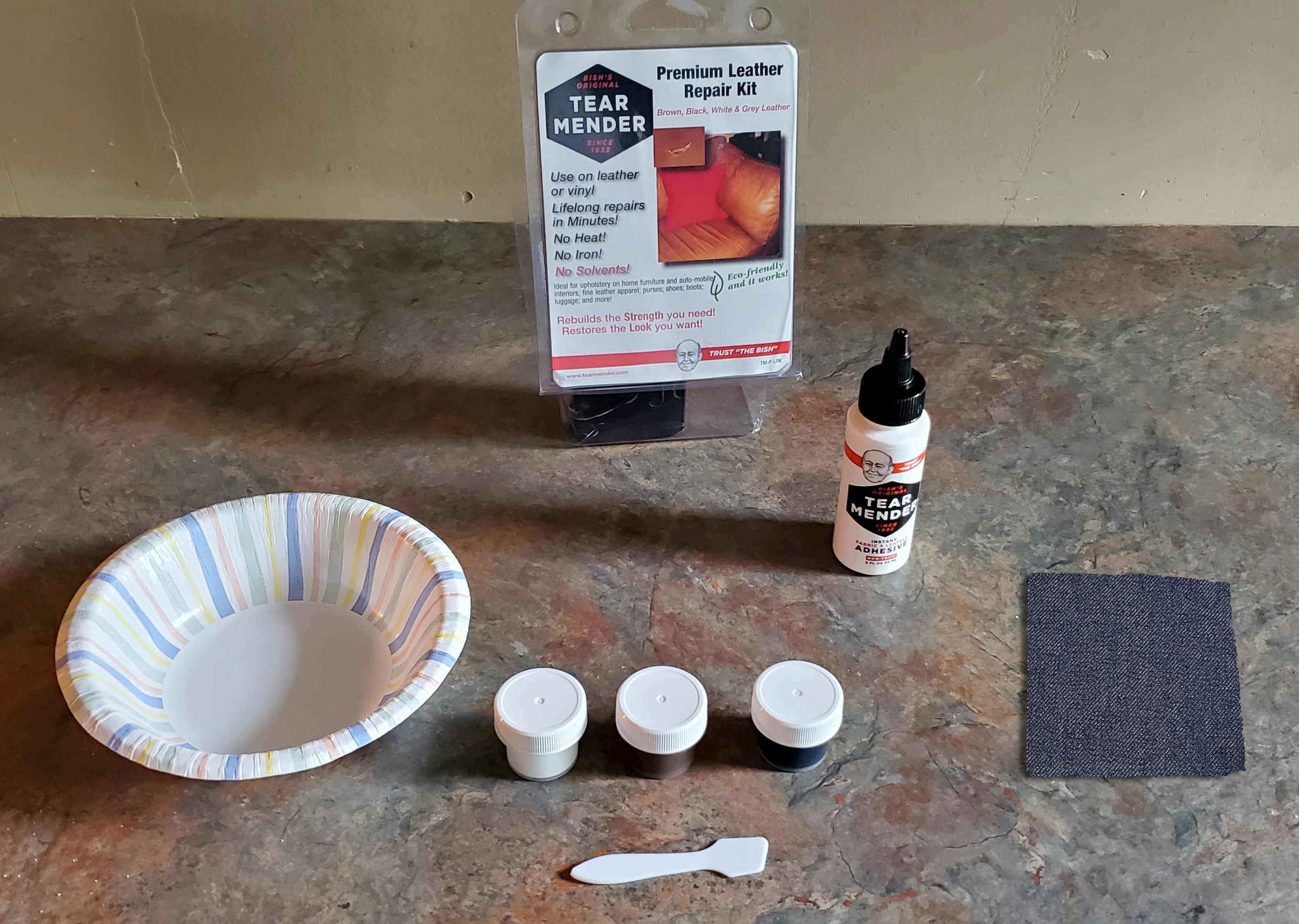 Leather repair kit with Tear Mender adhesive, color compounds, and denim patch for car seat repair