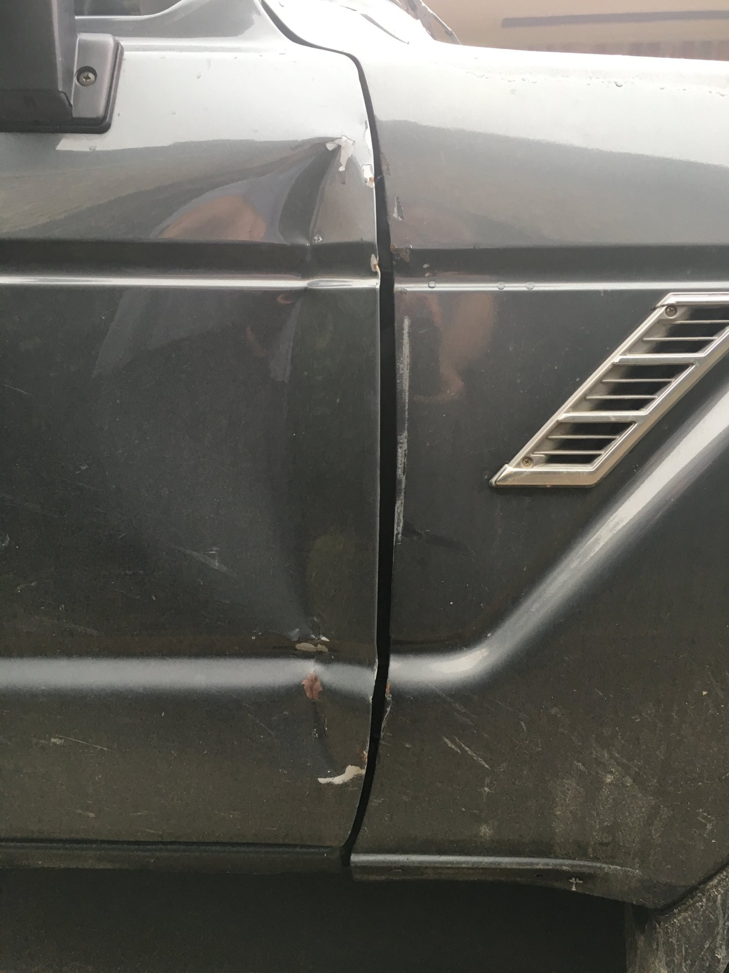 Bent car door and fender damage