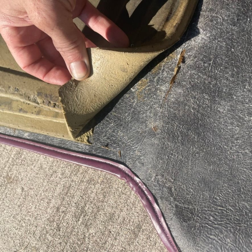 Applying liquid Flex Seal to the car mat backing for repair