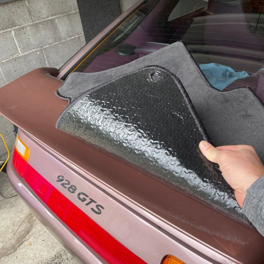 Close-up of repaired car mat, highlighting the restored rubber backing and flexibility