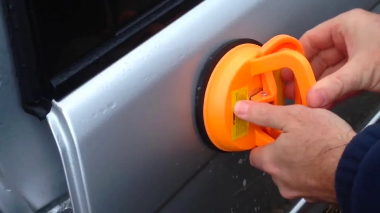 Car dent puller tool demonstrating DIY dent removal for minor vehicle damage.