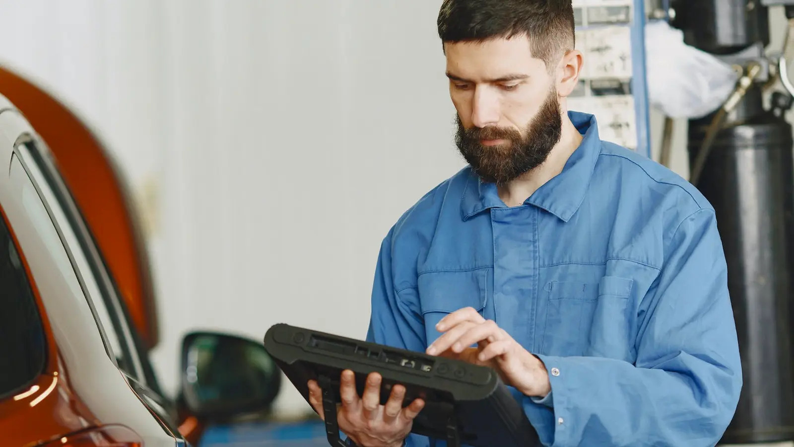 Man assessing car repair costs with a clipboard