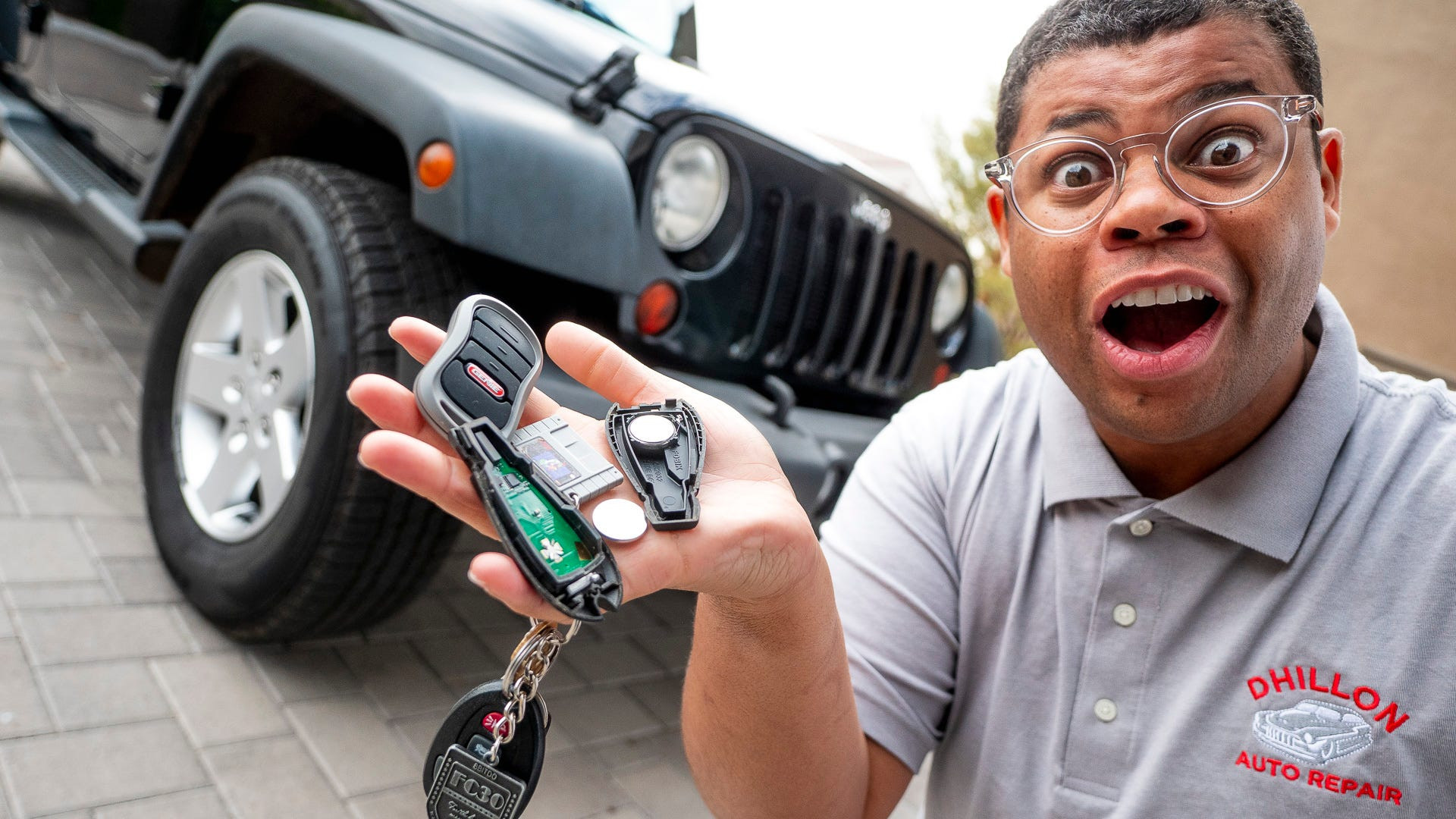 Close up of woman's hands opening car key fob to replace battery