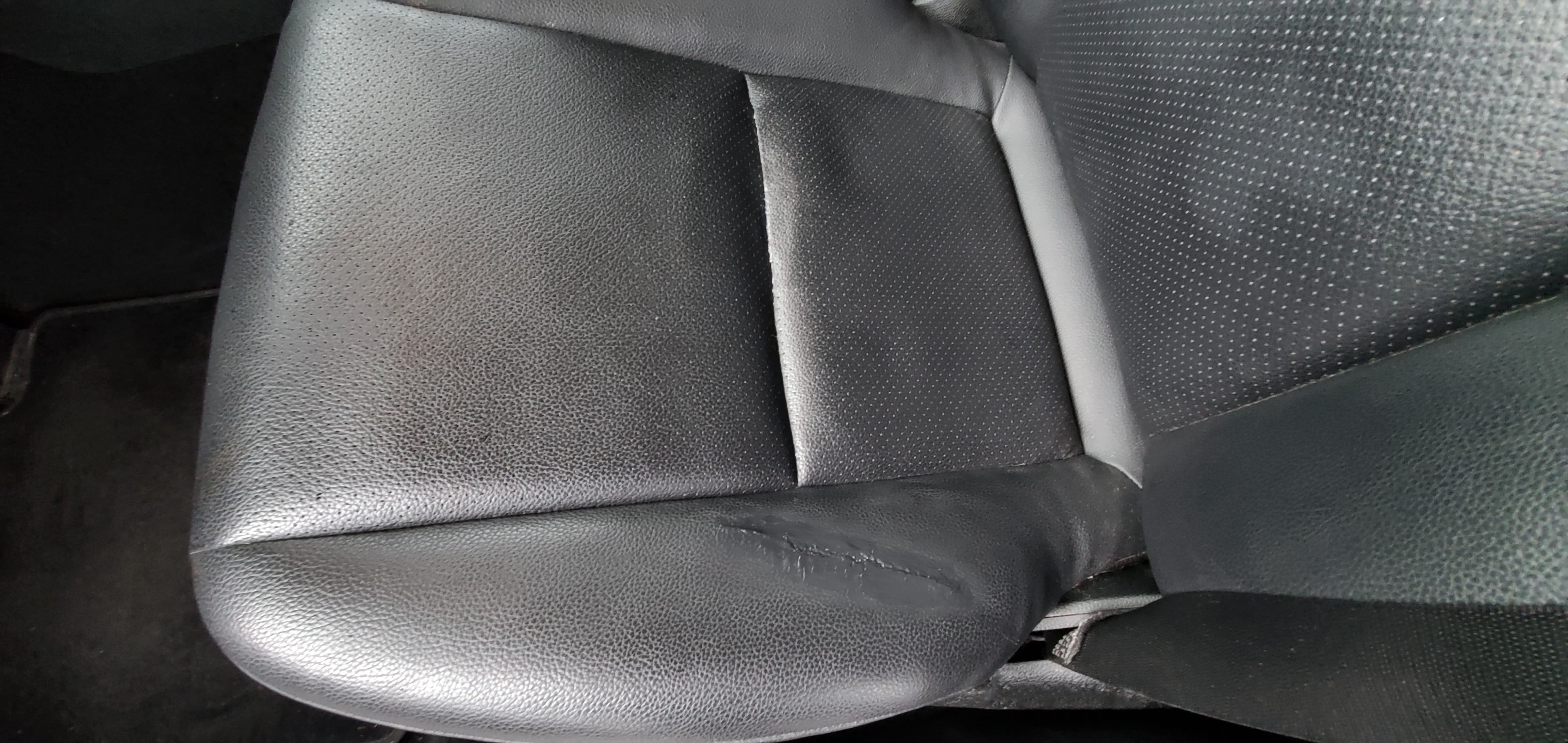 Final result of repaired torn leather car seat with color compound