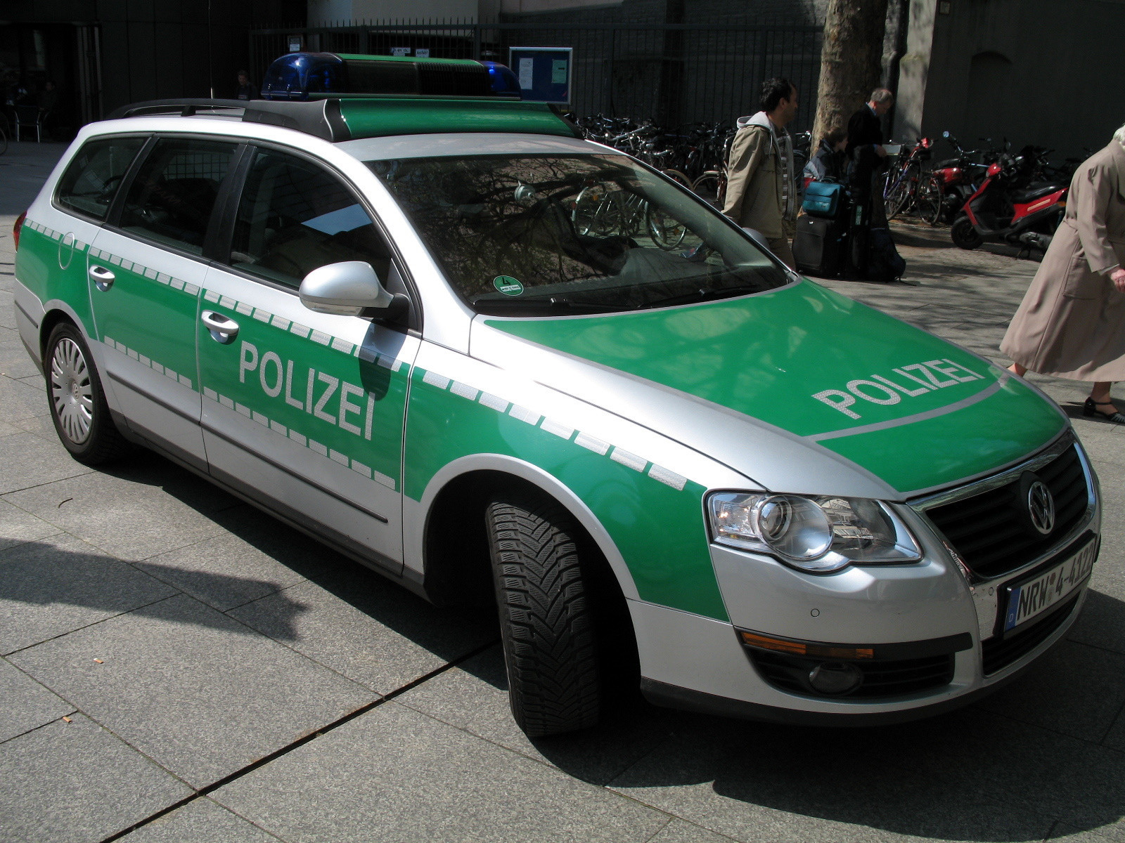 German police car roof showcasing a green vinyl wrap, an alternative solution to fixing peeling car paint, demonstrating the versatility of vinyl for vehicle customization.