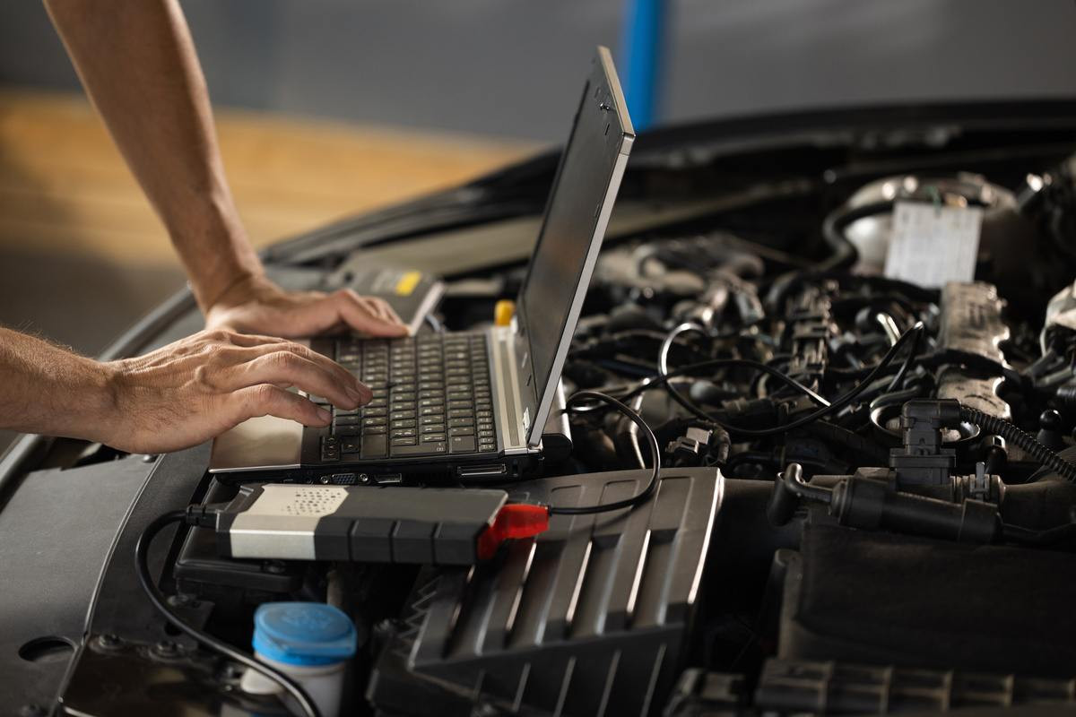 Mechanic skillfully utilizes automotive diagnostics tools to accurately repair a vehicle