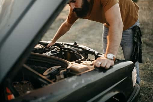 Mechanic inspecting car suspension