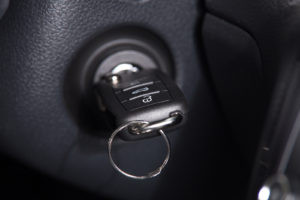 Close up of ignition cylinder and car key, symbolizing a key stuck in the ignition