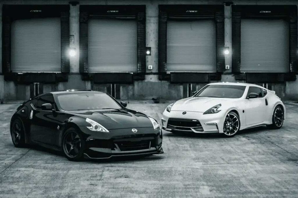 Black car and white car parked in a loading dock, illustrating vehicle parking and potential leak locations