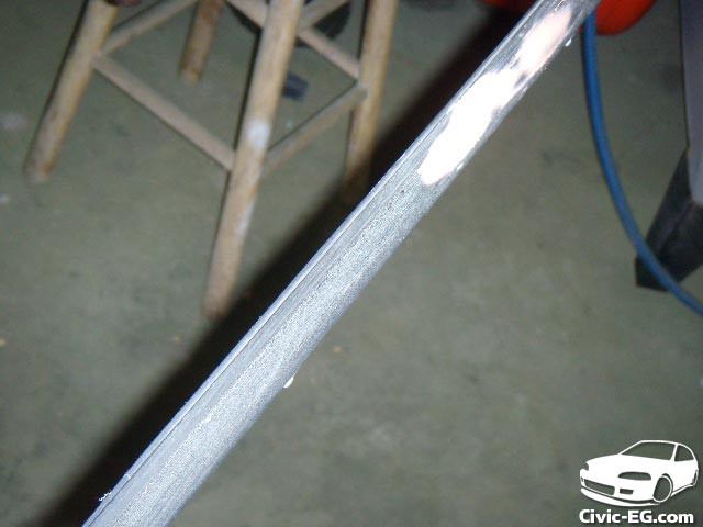 Close-up of removed car window trim, ready for sanding