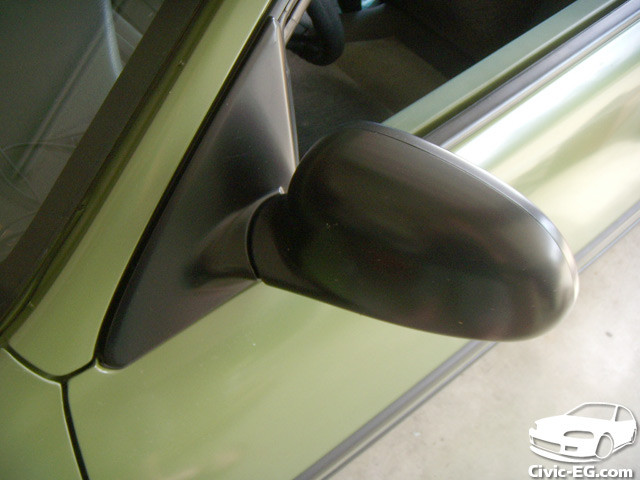 Close-up of restored car mirror trim painted with VHT trim paint