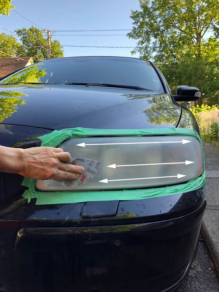 Horizontal sanding of a headlight with wet 3000 grit sandpaper.