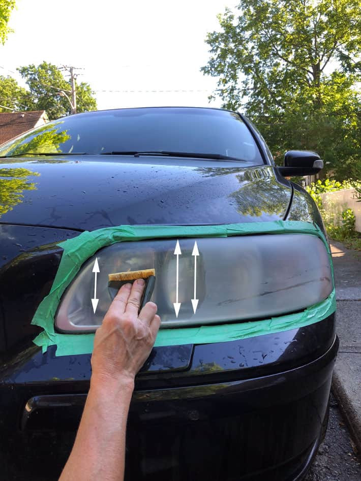 Vertical sanding of a headlight using wet 1500 grit sandpaper.