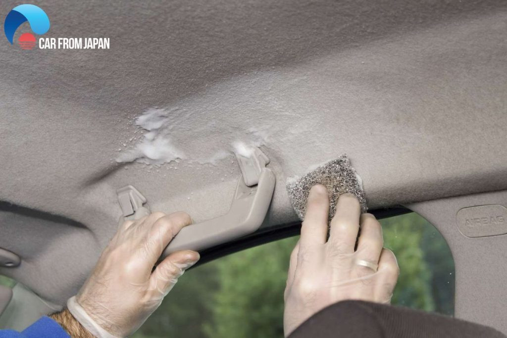 Close-up of a sagging car headliner, a common car interior problem caused by heat and adhesive failure.