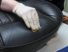 Sanding the rough edges of the car leather scratch