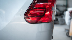 Close up of a car hood showing small paint chips and scratches from road debris