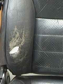 Leather car seat hole filled with multiple layers of heavy filler, nearly level