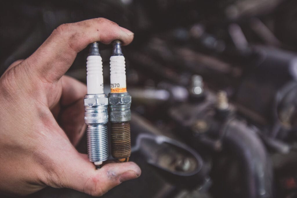 Close up of new and worn spark plugs