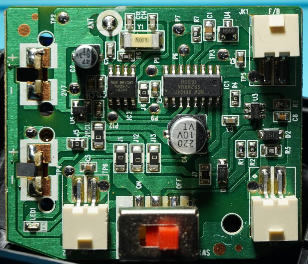 Detailed view of the circuit board in a New Bright RC car, illustrating the basic electronics that might require fixing or upgrading in RC car mods.