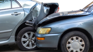 Car with rear-end damage, including a crushed trunk and bumper, representing major collision damage