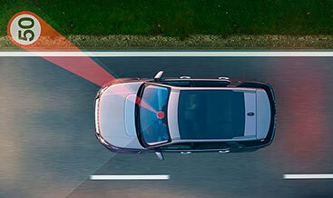 Discovery Sport instrument cluster displaying a speed limit sign through Traffic Sign Recognition.