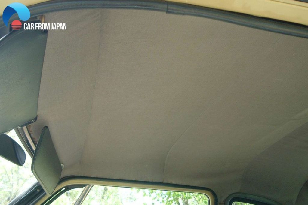 Close-up of a car headliner showing the fabric and texture, illustrating what a car inside roof liner is.