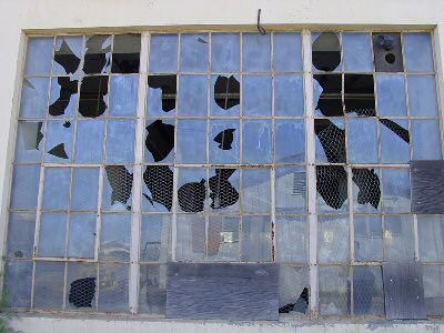 Broken car window symbolizing neglect and the need for prompt repair